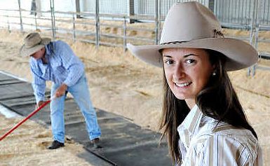 Settling in: Gympie Showgirl Andrea Schultz watches on as stud beef pavilion volunteers get the bedding ready for the cattle. Settling in: Gympie Showgirl Andrea Schultz watches on as stud beef pavilion volunteers get the bedding ready for the cattle.